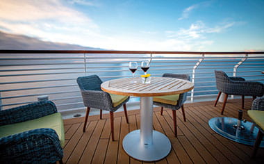Glasses of red wine on a table on the Verandah aboard Spirt of Discovery